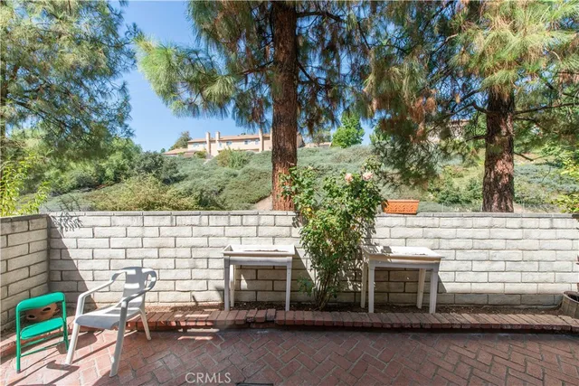 a view of backyard with barbeque grill and seating area
