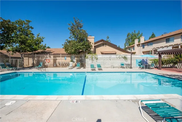a view of house with swimming pool having outdoor seating
