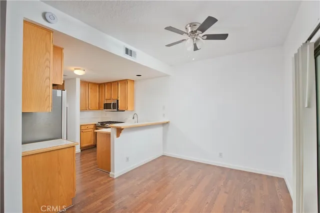 a view of a kitchen with a sink and a refrigerator