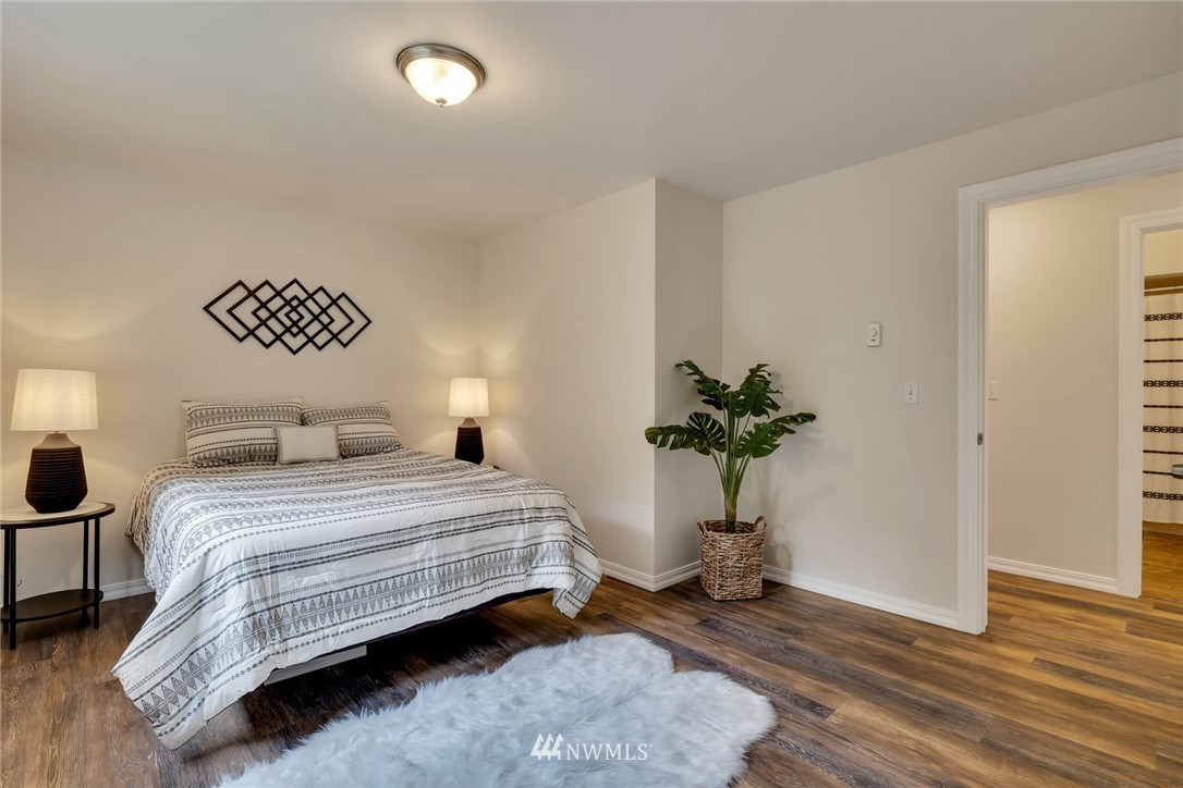 20260 Maxwell Road Southeast Maple Valley, WA 98038 - Photo 13 of 38 a bedroom with a bed and a potted plant