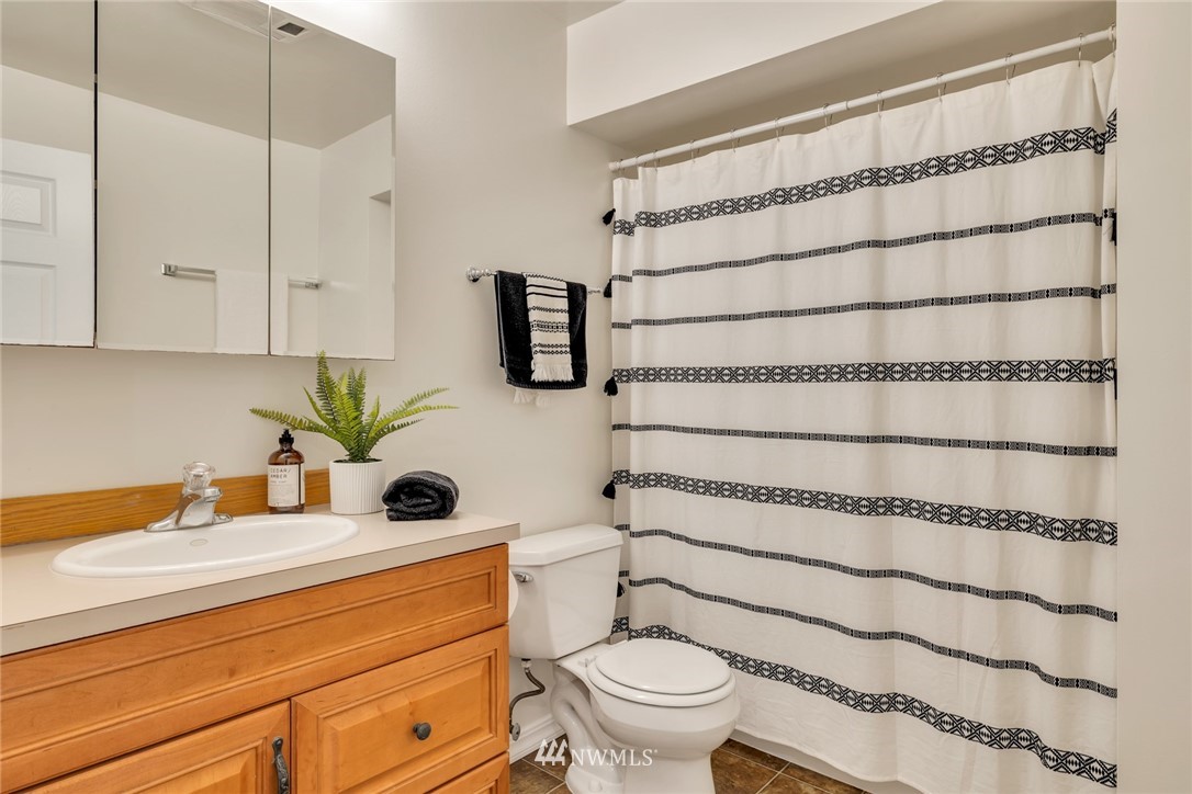 20260 Maxwell Road Southeast Maple Valley, WA 98038 - Photo 15 of 38 a bathroom with a sink toilet and shower