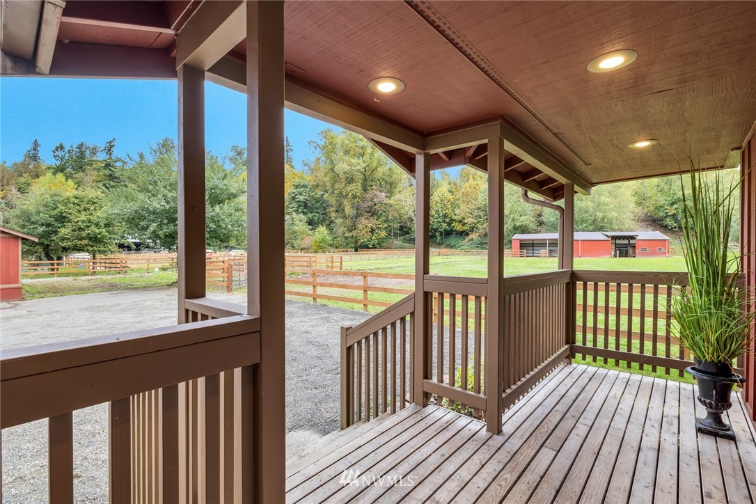 20260 Maxwell Road Southeast Maple Valley, WA 98038 - Photo 3 of 38 a view of a porch with wooden floor in front of glass door