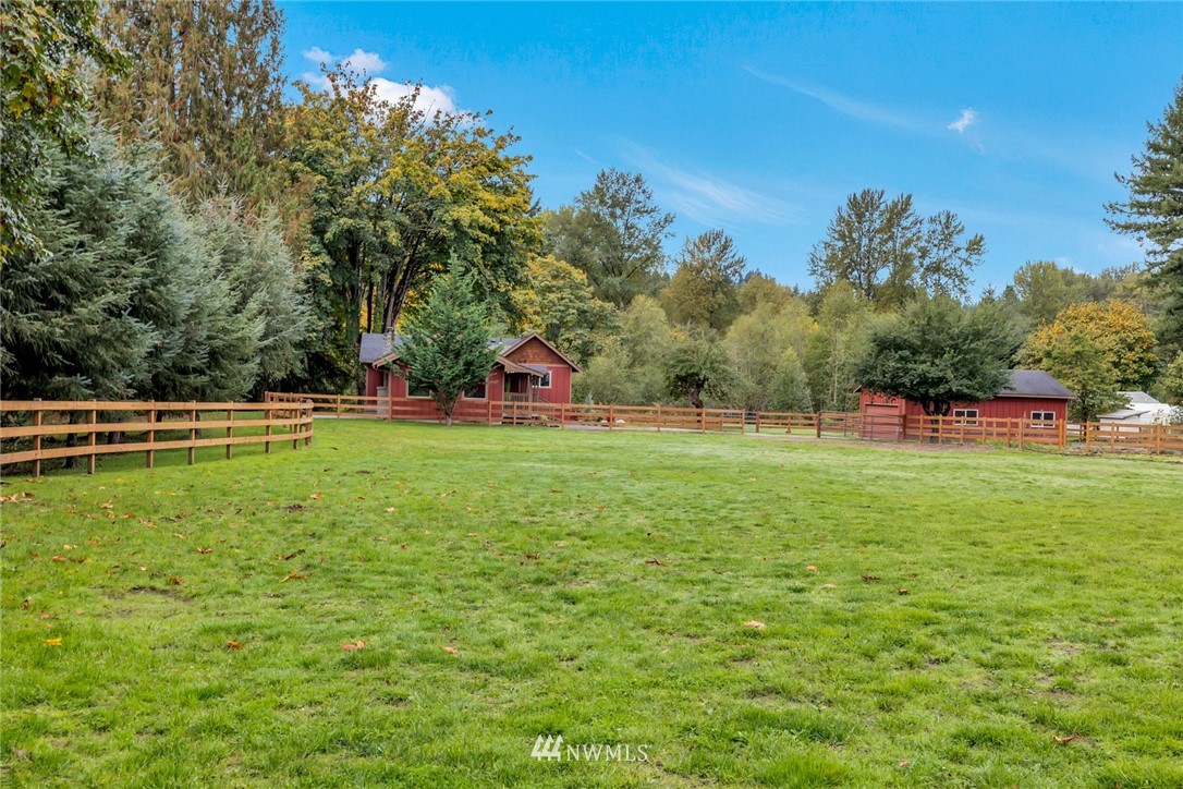 20260 Maxwell Road Southeast Maple Valley, WA 98038 - Photo 35 of 38 a view of green field with trees in the background