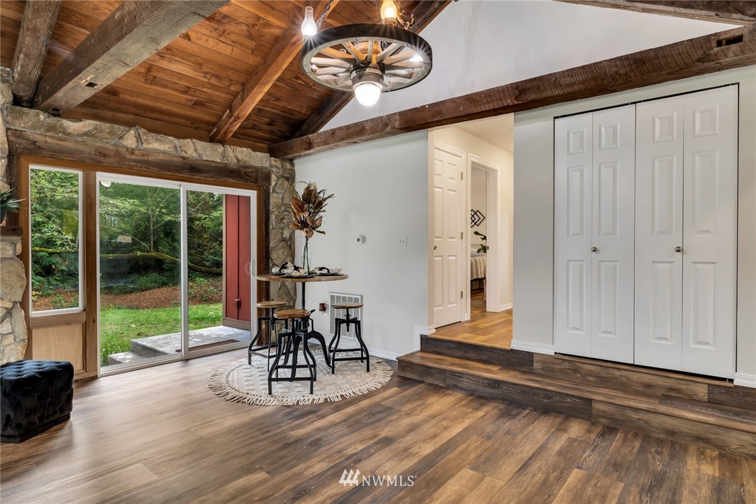 20260 Maxwell Road Southeast Maple Valley, WA 98038 - Photo 8 of 38 a view of a porch with furniture and floor to ceiling window