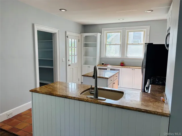 a table with a large window and wooden floor