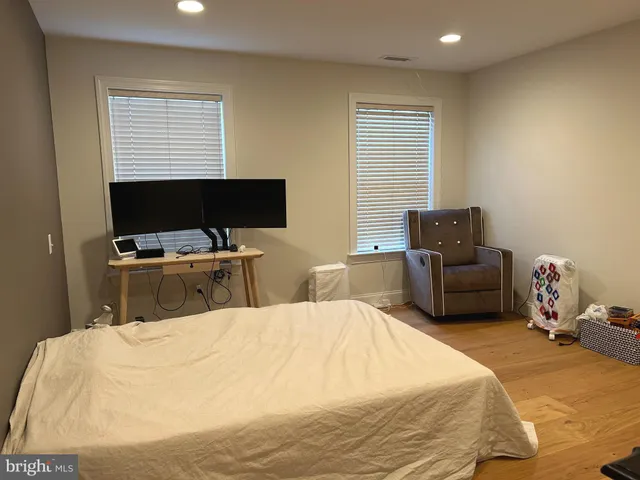 a bedroom with a bed and computer