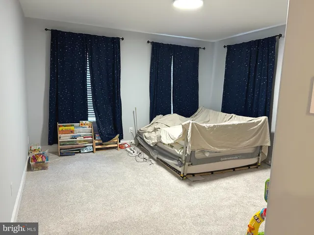 a bedroom with bed and gym equipment