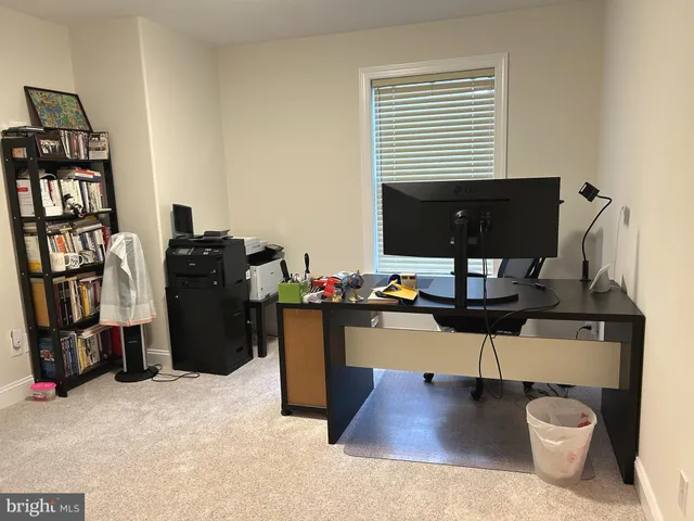 a view of workspace with furniture and book shelf