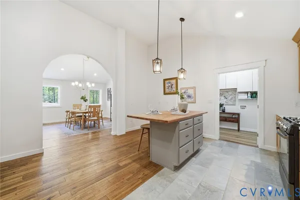 a kitchen with counter top space and wooden floor