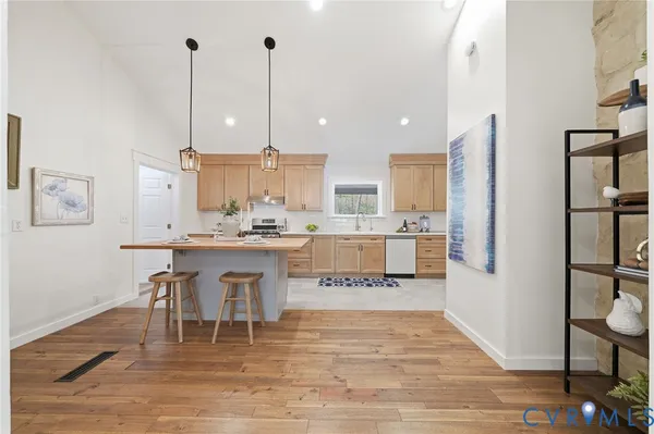 a large kitchen with a table and chairs
