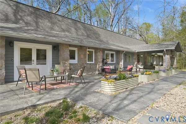 a view of a patio with table and chairs and potted plants