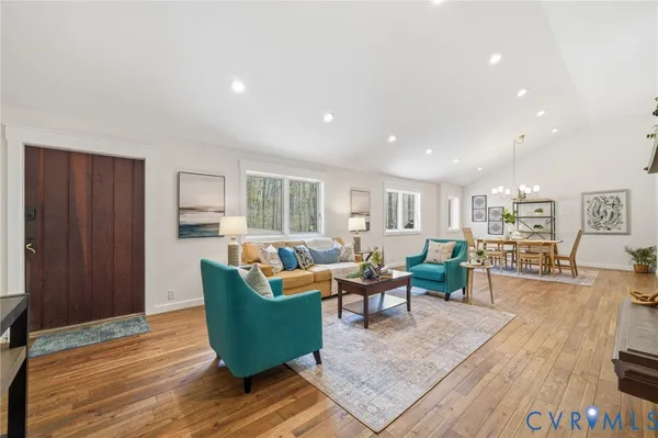 a living room with furniture and a wooden floor
