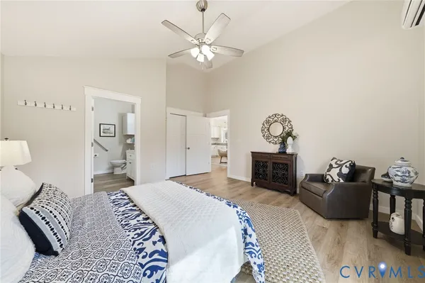 a spacious bedroom with a bed and a chandelier