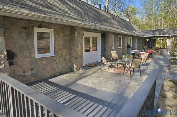 a view of a patio with table and chairs with wooden floor