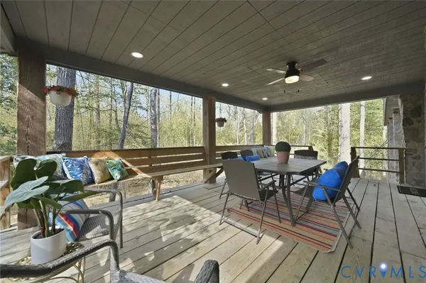 a view of a dining room with furniture large windows and wooden floor