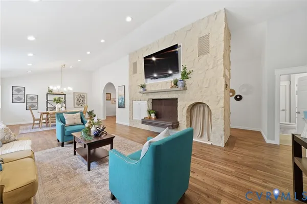 a living room with furniture a fireplace and a flat screen tv