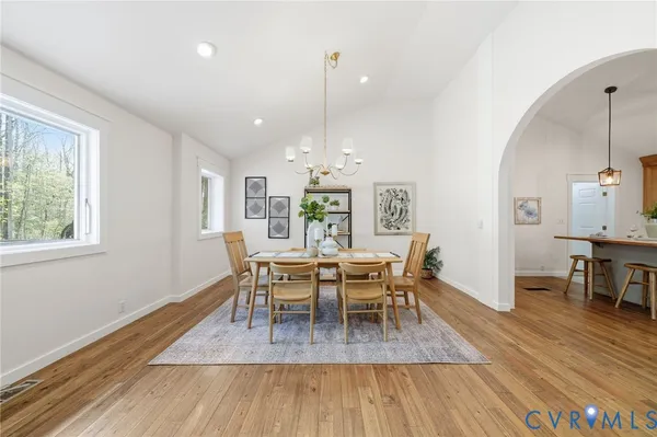 a view of a dining room with furniture and wooden floor