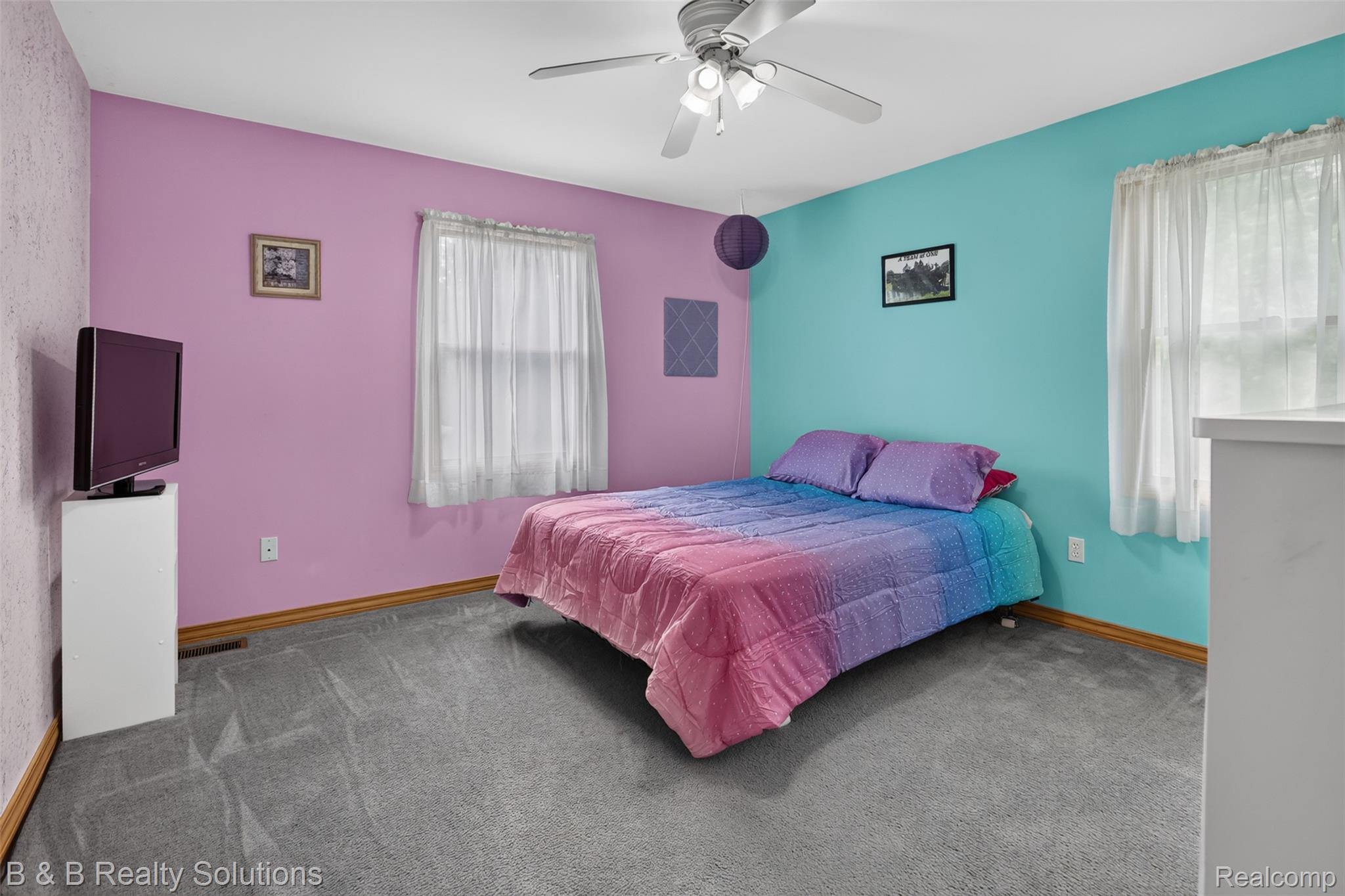 3097 East Burnside Road North Branch, MI 48461 - Photo 26 of 52 Bedroom with gray carpet flooring, a ceiling fan with integrated lighting, two windows with white sheer curtains, and light wood baseboards