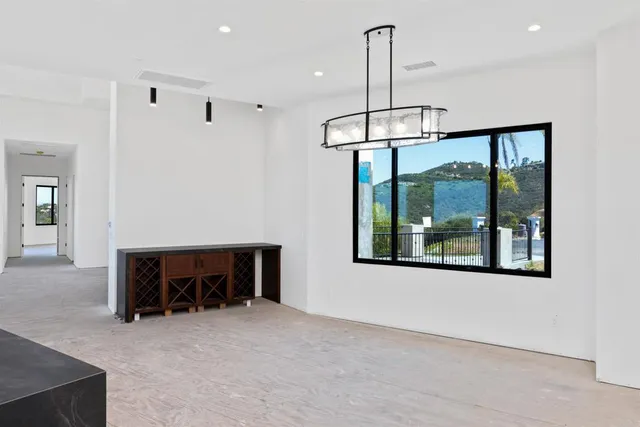 a view of a livingroom with furniture window and chandelier