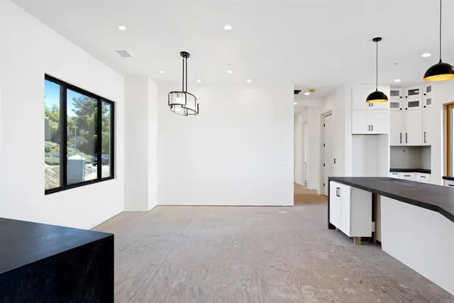 a kitchen with stainless steel appliances granite countertop a sink a stove and a refrigerator