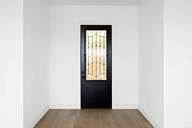a view of an entryway with wooden floor
