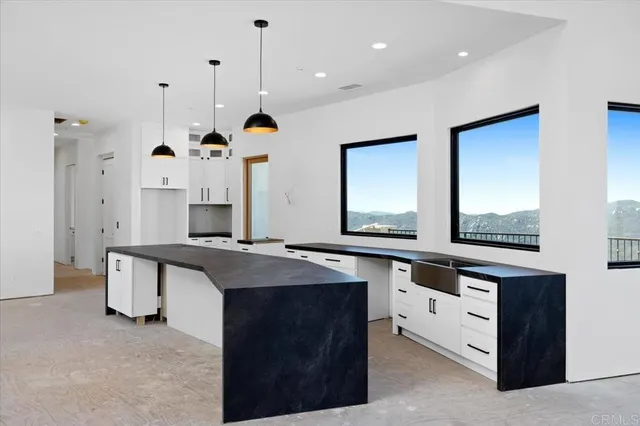 a kitchen with stainless steel appliances granite countertop a sink a stove and a refrigerator