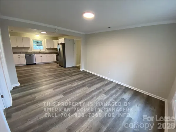 a view of a kitchen with a sink and a refrigerator