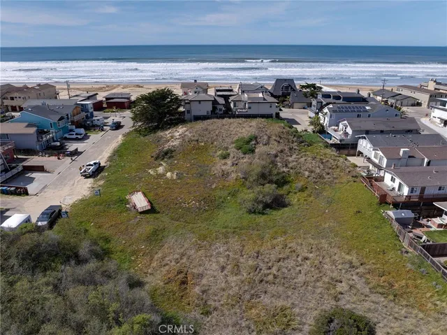 a backyard of a house with a yard and outdoor seating