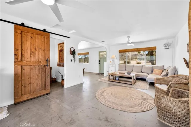 a living room with dining table and chairs