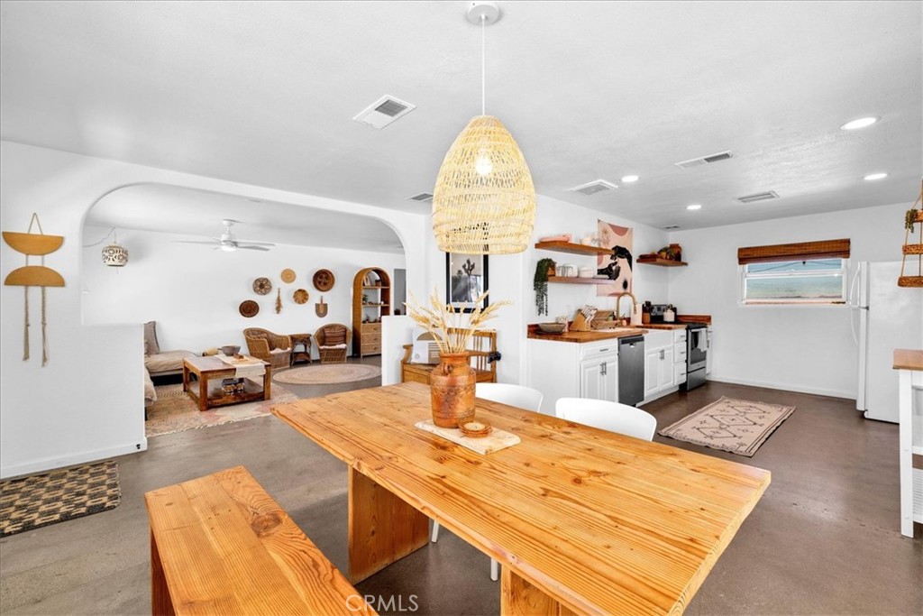 59700 Napa Road Landers, CA 92285 - Photo 17 of 68 a living room with dining table and chairs
