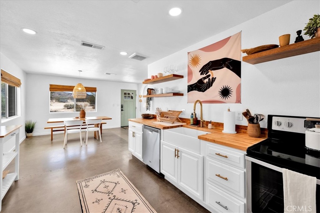 59700 Napa Road Landers, CA 92285 - Photo 20 of 68 a kitchen with a sink dishwasher and a stove with wooden floor