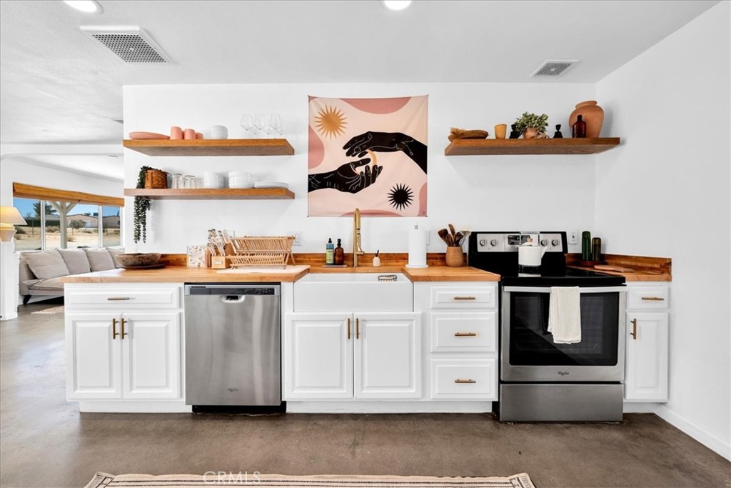 59700 Napa Road Landers, CA 92285 - Photo 21 of 68 a kitchen with cabinets and white appliances