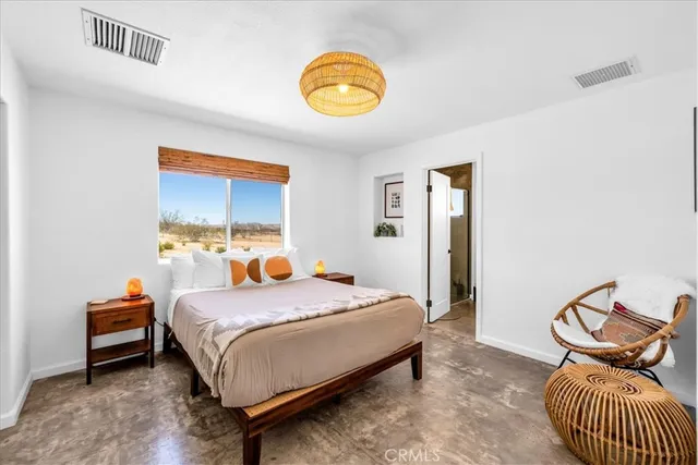 a bedroom with a bed and window