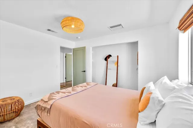 a view of a room with wooden floor and window
