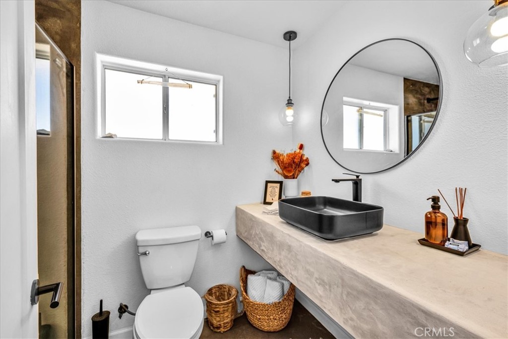 59700 Napa Road Landers, CA 92285 - Photo 25 of 68 a bathroom with a toilet sink and mirror