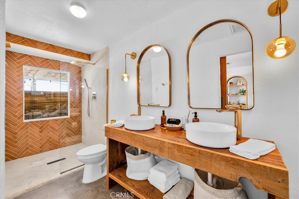 59700 Napa Road Landers, CA 92285 - Photo 32 of 68 a bathroom with a granite countertop sink mirror and toilet