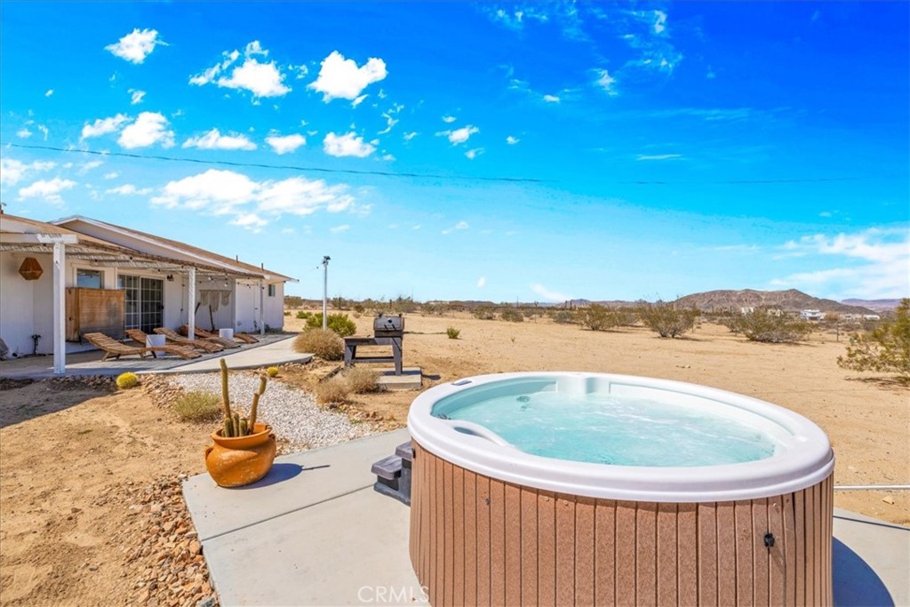 59700 Napa Road Landers, CA 92285 - Photo 38 of 68 a view of a swimming pool with a patio and a yard