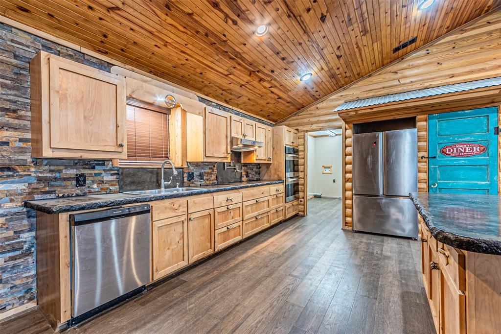 1398 Zagota Crossing Road Terrell, TX 75161 - Photo 11 of 40 a view of a kitchen with stainless steel appliances granite countertop a stove a sink and a microwave