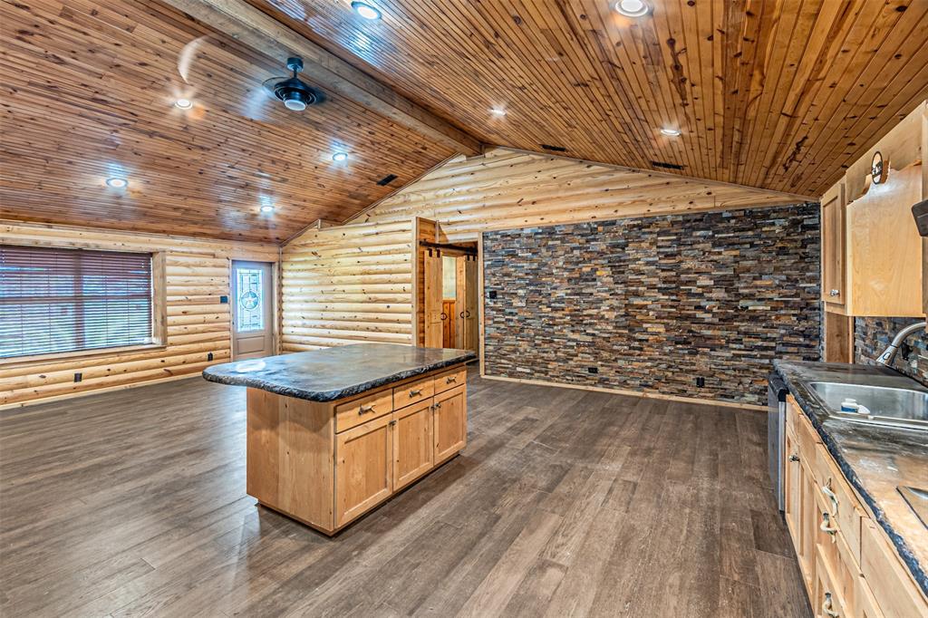 1398 Zagota Crossing Road Terrell, TX 75161 - Photo 12 of 40 a kitchen with granite countertop wooden floors and sink