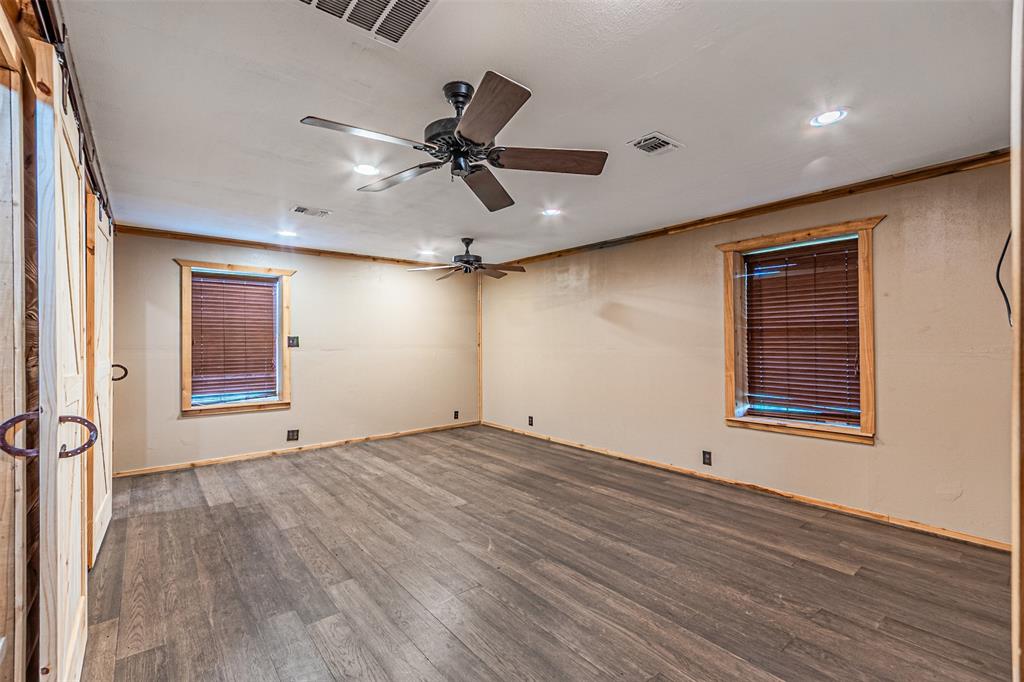 1398 Zagota Crossing Road Terrell, TX 75161 - Photo 13 of 40 a view of an empty room with wooden floor and a window
