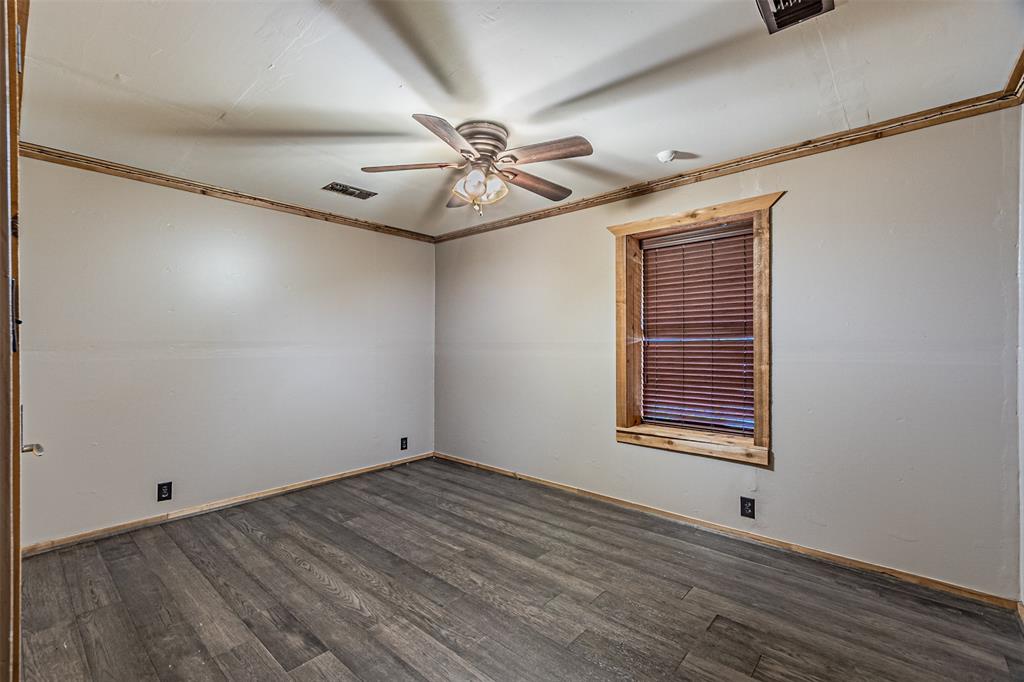 1398 Zagota Crossing Road Terrell, TX 75161 - Photo 22 of 40 a view of an empty room with wooden floor and a window