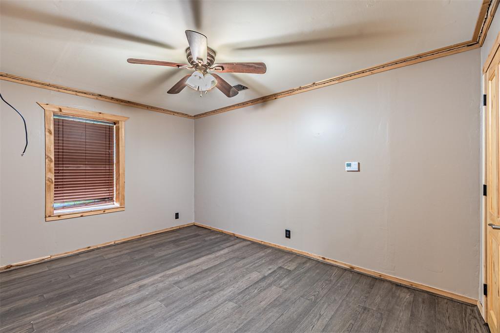 1398 Zagota Crossing Road Terrell, TX 75161 - Photo 24 of 40 an empty room with wooden floor fan and windows