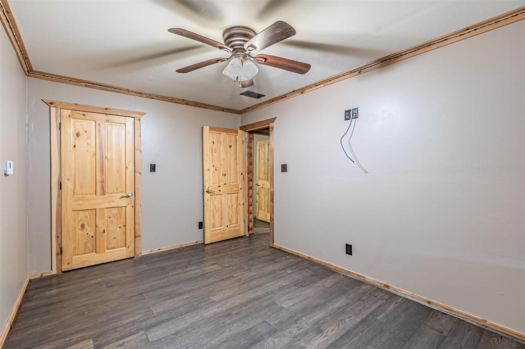 1398 Zagota Crossing Road Terrell, TX 75161 - Photo 25 of 40 a view of a livingroom with a chandelier fan and wooden floor