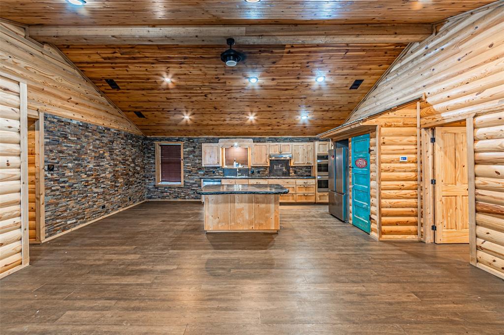 1398 Zagota Crossing Road Terrell, TX 75161 - Photo 6 of 40 a kitchen with stainless steel appliances wooden floor and chandelier