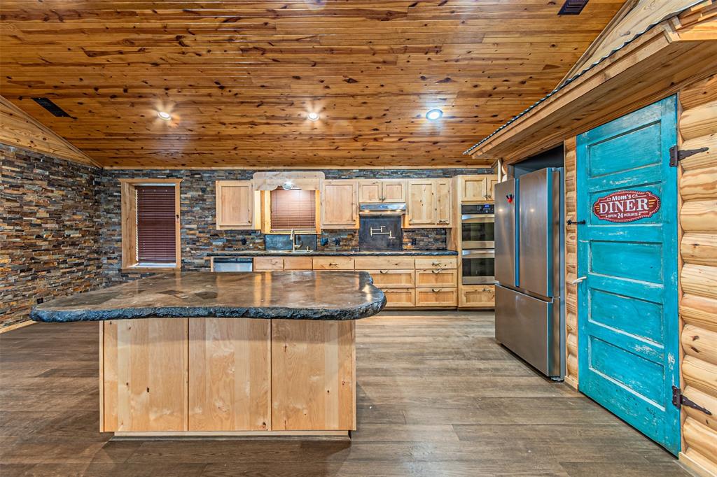 1398 Zagota Crossing Road Terrell, TX 75161 - Photo 8 of 40 a view of a kitchen with stainless steel appliances granite countertop a stove and a refrigerator