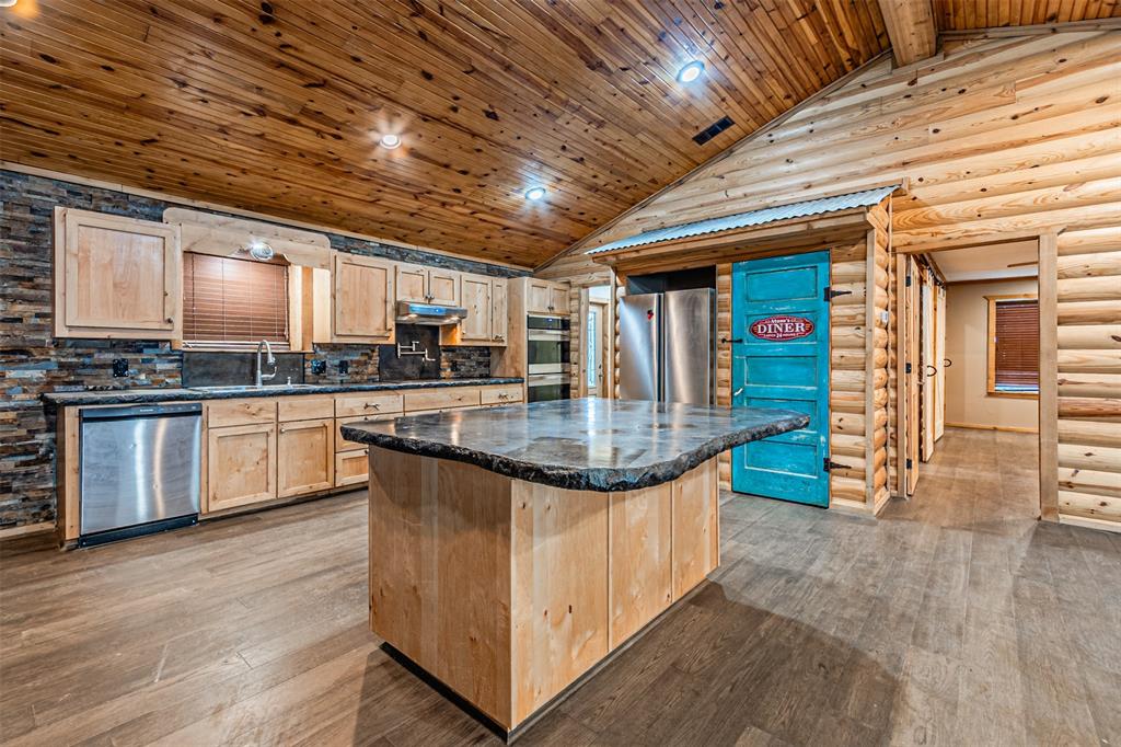 1398 Zagota Crossing Road Terrell, TX 75161 - Photo 9 of 40 a kitchen with stainless steel appliances granite countertop a stove a sink and a microwave