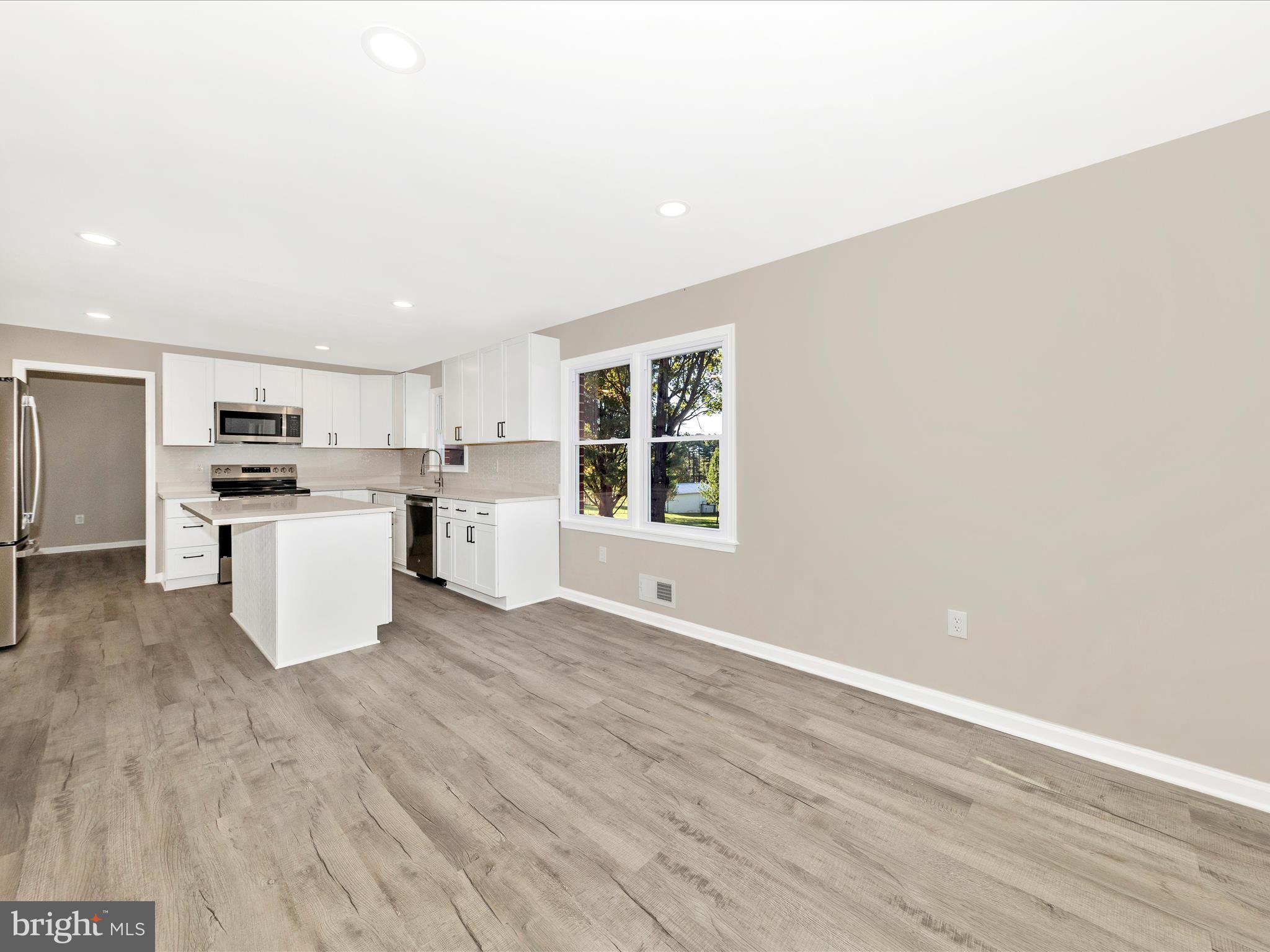 2431 Quebec School Road Middletown, MD 21769 - Photo 22 of 56 a kitchen with a refrigerator and a stove top oven