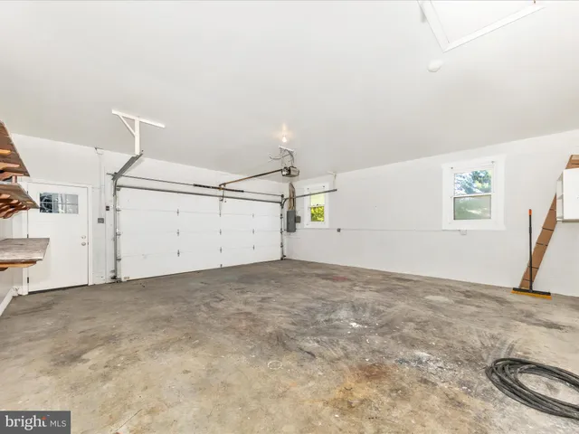 a view of a hallway with wooden floor and entryway