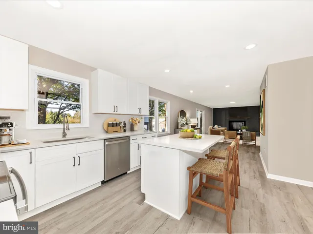 a kitchen with sink cabinets and wooden floor