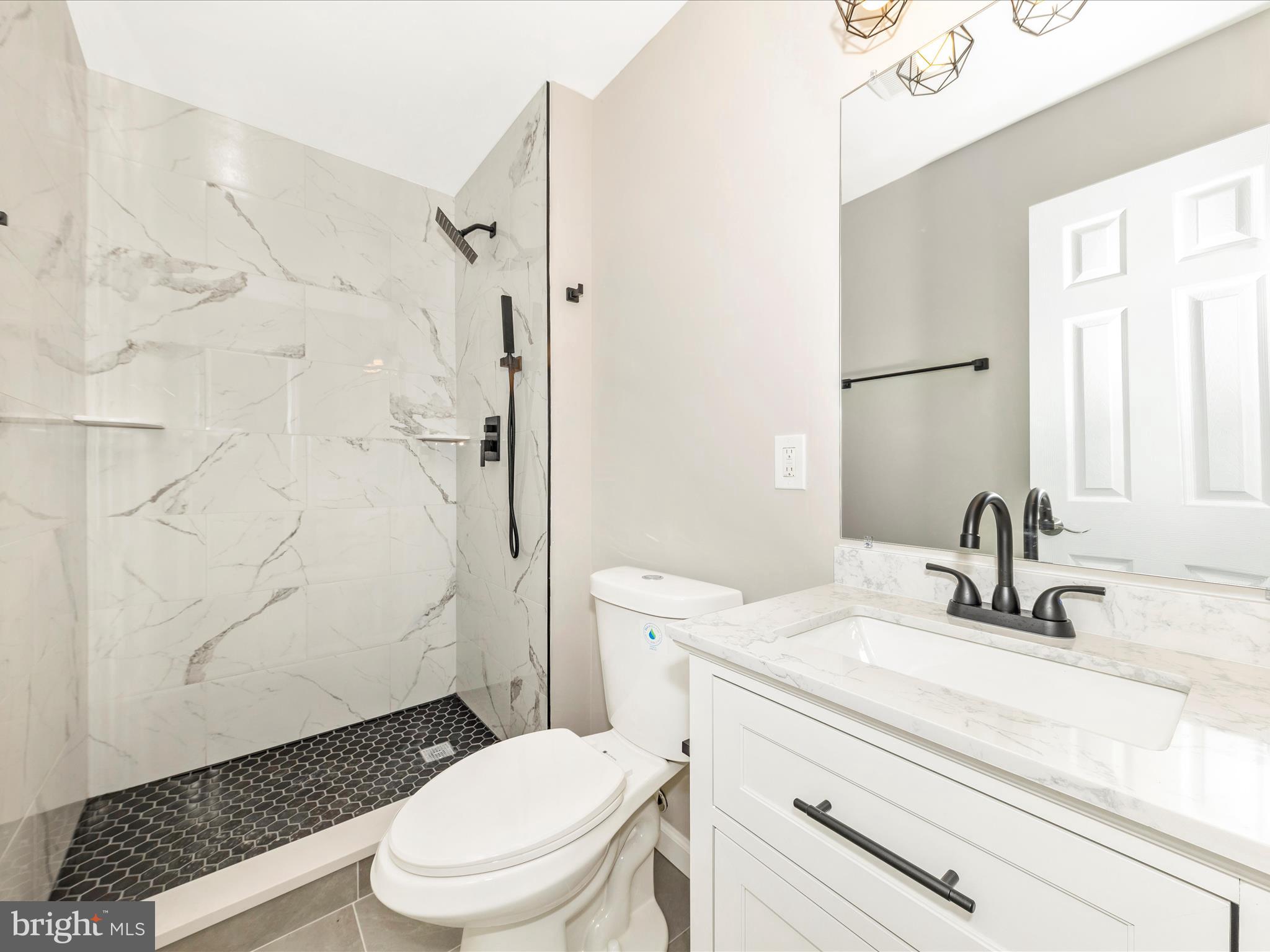 2431 Quebec School Road Middletown, MD 21769 - Photo 31 of 56 a bathroom with a sink toilet vanity and shower